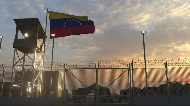 National flag of Venezuela above military base at sunset