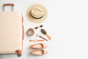 Packed suitcase and accessories on white background