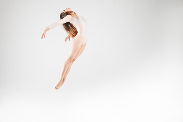 Jumping dancer in bright clothes on a white background. Jump, fly, air, beautiful, pose