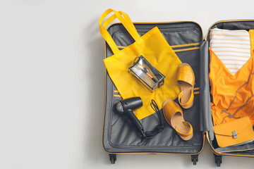 Open packed suitcase on white background