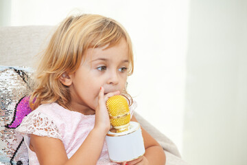 little girl with a microphone for karaoke