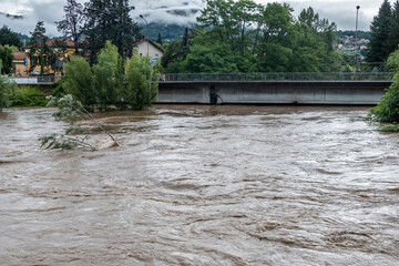 Climate change: flooding river hits the bridge after a storm in Luino