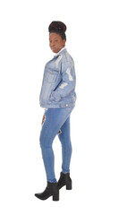 Beautiful African woman standing in jeans in the studio