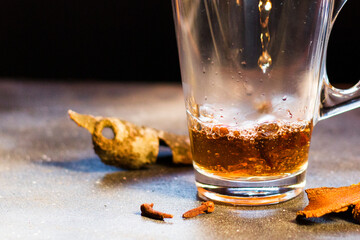 Grog in the tea glass, rum and warm tea with cinnamon