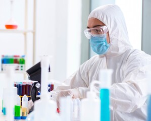Young chemist student working in lab on chemicals