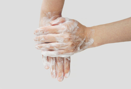 Woman washes hands with soap, hands in foam