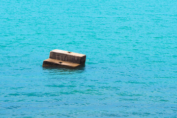 Part of abandoned concrete pier. Old and broken pier into the sea