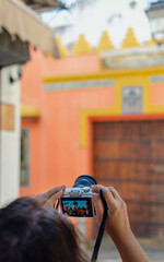 Selective focus on the hands of a caucasian woman taking picture on a touristic Street of Seville, Spain after coronavirus lockdown