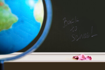Inscription Back to school on the school blackboard, the globe. Back to school concept