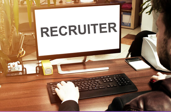 Male And Female Hand, Computer With Text RECRUITER With Office Background