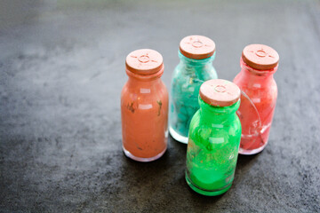 Whole and cracked glass bottles with rubber corks and dried old artistic paint