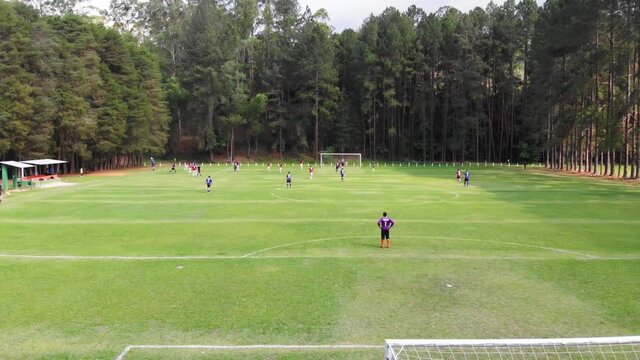 Drone image of soccer game in beautiful woodland setting. São Paulo, Brazil.