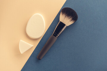 cosmetic accessories on a colored background top view