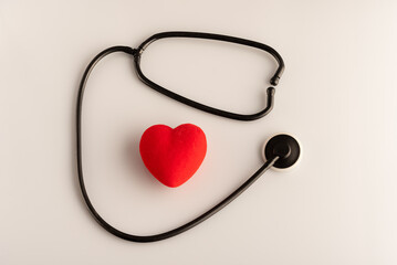 Stethoscope with red heart on white background