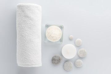 Fototapeta na wymiar Top view of organic spa products with salt, candle, towel and stone