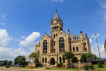 Fototapeta na wymiar The Historical old Victoria County Courthouse built in 1892 looks like a castle. It stands next to De Leon Plaza on the main square in Victoria, Texas.
