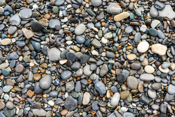 Tropical wet pebbles background. Loo beach,