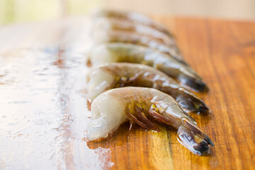 Raw shrimps on the wooden board