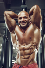 Fototapeta na wymiar Bodybuilder strong man pumping up abs muscles