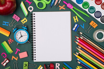 Fototapeta premium Top above overhead view photo of blank notebook with colorful stationery isolated on greenboard