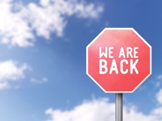 We are back - Road sign on blue sky background