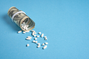 pills empty blisters for drugs individual syringe and money lie on a blue background