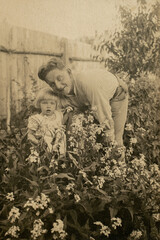 Latvia - CIRCA 1930s: Portrait of daughter and father in garden. Vintage archive Art Deco era photography