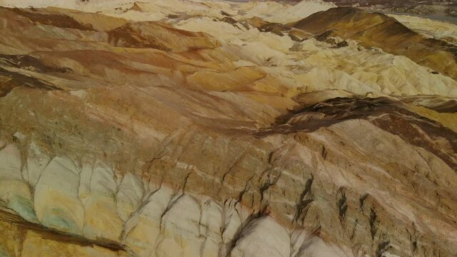 Aerial flyover of colorful sandstone formations in Mojave Desert, California