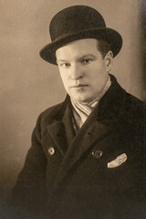 Germany - CIRCA 1930s: Man in coat portrait in studio. Close up. Vintage art deco era photo