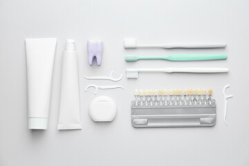 Set for oral hygiene with teeth color samples on white background