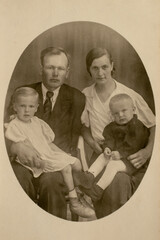 Germany - CIRCA 1930s: A family studio shot of married couple with two children in studio. Vintage art deco era photo