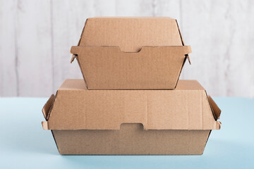 Two different size burger boxes standing on each other