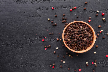A set of peppers.Collage of different type pepper, Black ,white, pink and allspice peppercornsr, dried chili pepper.Top view. On a black background. free space for your text.
