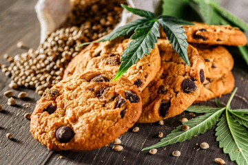Cookies with cannabis and buds of marijuana on the table. A can of cannabis buds CBD Concept of...