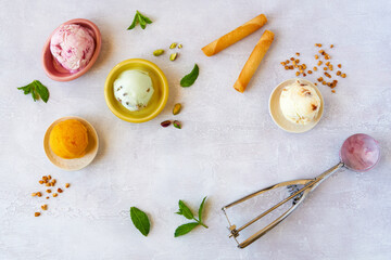 Fototapeta na wymiar Set of soft ice cream scoops or frozen yogurt, sorbet of different flavours . Top view