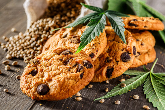 Cookies with cannabis and buds of marijuana on the table. A can of cannabis buds CBD Concept of cooking with cannabis herb. - Medical Legal Marijuana