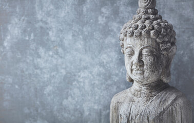 Fototapeta na wymiar Meditating Buddha Statue on bright background. Copy space.
