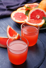 Glasses of fresh grapefruit juice on table