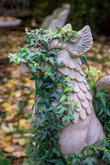 Gargoyle statue draped in ivy