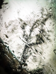 Waterdrops on the car window - blurred cityscape on the background