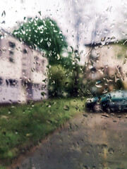 Waterdrops on the car window - blurred cityscape on the background