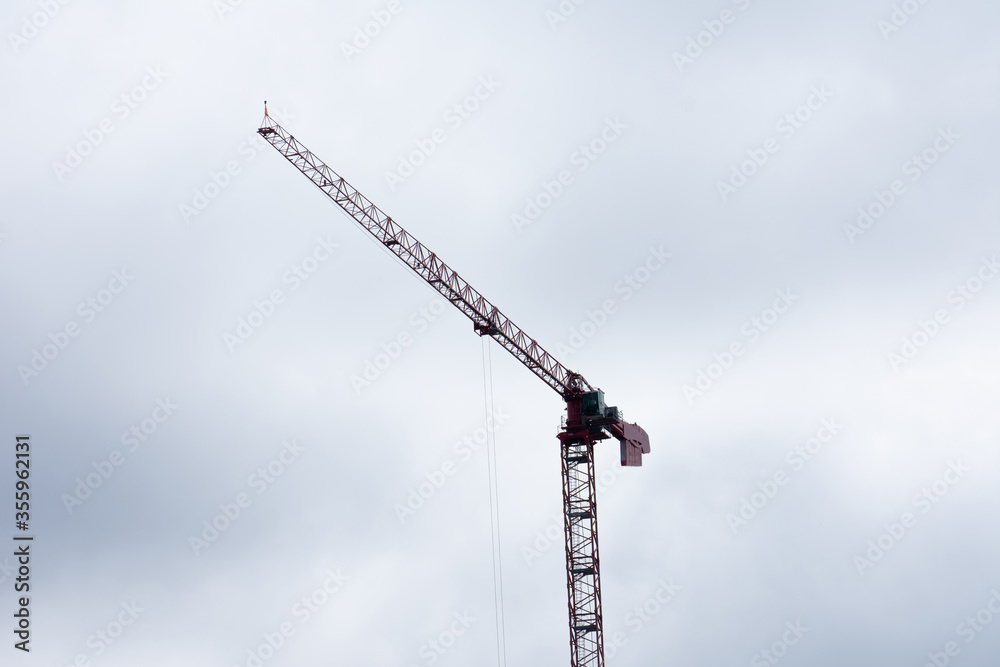 Wall mural a construction crane with a sky background backdrop landscape view for a modern infrastructure and a