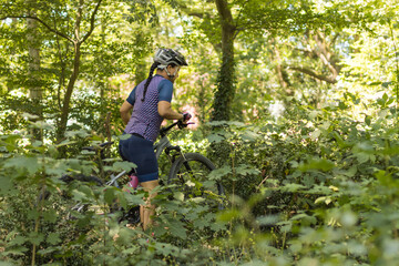 woman doing mountain biking among nature