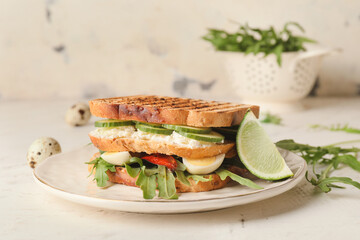 Plate with tasty cucumber sandwich on table