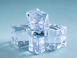 Pile of plastic ice cubes isolated on blue background