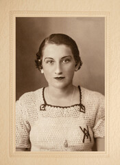 Germany - CIRCA 1930s: Portrait of  young pretty female. Close up woman face. Vintage Art Deco era photo in paper frame. 