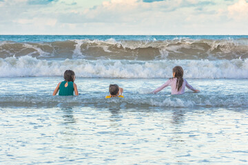 Children friends playing relaxed on the beach on a beautiful day