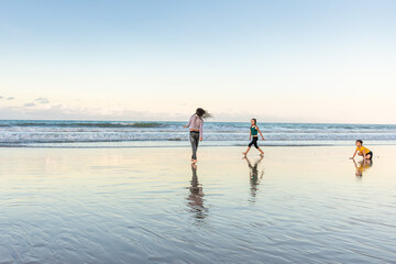 Fototapeta na wymiar Children exercising on the beach juggling joy