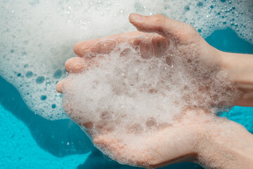 foam in the hands, soap bubbles in the palms, the concept of washing, cleanliness, hand wash