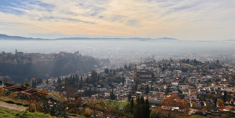 Panoramic view of the city of Granada, partially covered by haze, from San Miguel Alto